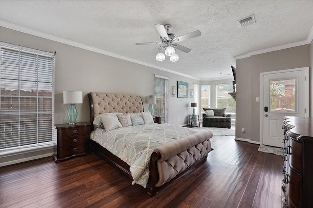 bedroom with a textured ceiling, visible vents, crown molding, baseboards, and dark wood-style floors