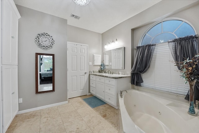 full bath featuring visible vents, tile patterned flooring, a tub with jets, vanity, and ensuite bathroom