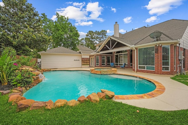view of swimming pool with fence, a patio, and a pool with connected hot tub