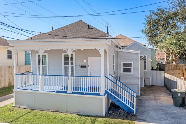 511 9th St, Galveston, TX 77550 - view of front of house featuring roof with shingles, covered porch, and fence