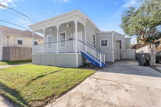 shotgun-style home with fence, a front lawn, ceiling fan, a gate, and covered porch