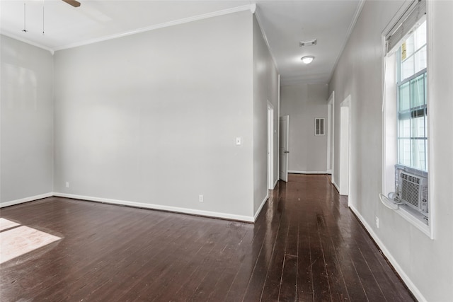 hallway with wood-type flooring, baseboards, visible vents, and ornamental molding