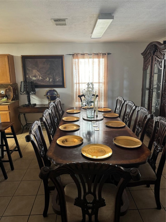 18207 Sea Branch Dr, Houston, TX 77084 - dining area featuring light tile patterned floors, a textured ceiling, and visible vents