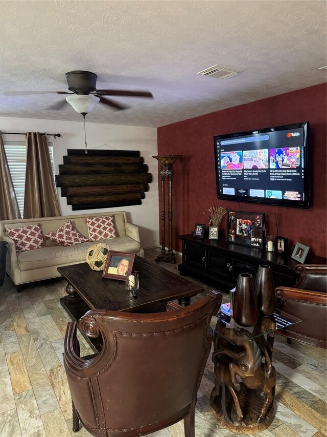 18207 Sea Branch Dr, Houston, TX 77084 - living room featuring stairway, a ceiling fan, a textured ceiling, and visible vents