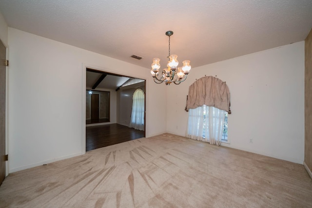 unfurnished dining area featuring carpet floors, a notable chandelier, and visible vents