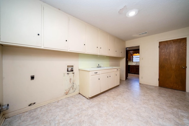 laundry room featuring baseboards, light floors, cabinet space, washer hookup, and hookup for an electric dryer