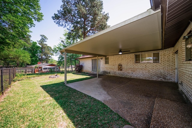 view of yard with a fenced backyard, ceiling fan, and a patio area