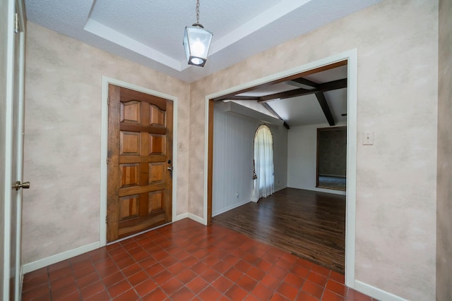 tiled foyer with arched walkways, baseboards, lofted ceiling with beams, and a textured ceiling