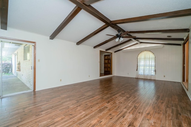 unfurnished living room with vaulted ceiling with beams, ceiling fan, and wood finished floors