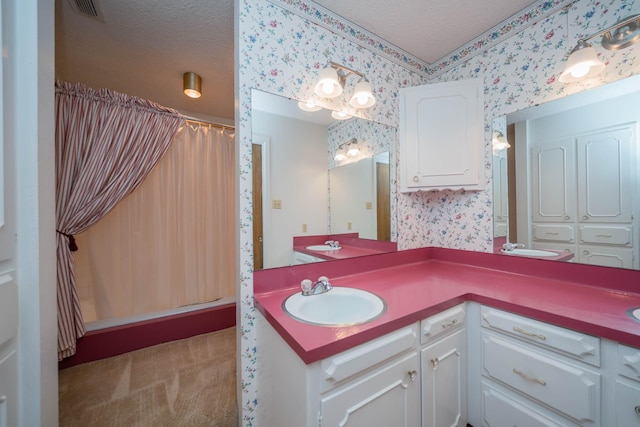 full bath featuring a textured ceiling, wallpapered walls, a shower with shower curtain, and vanity
