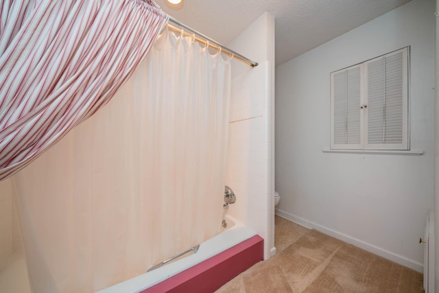 bathroom featuring baseboards, shower / tub combo, and toilet