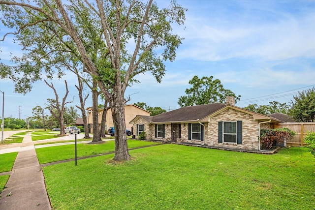 ranch-style home with fence, a chimney, and a front yard