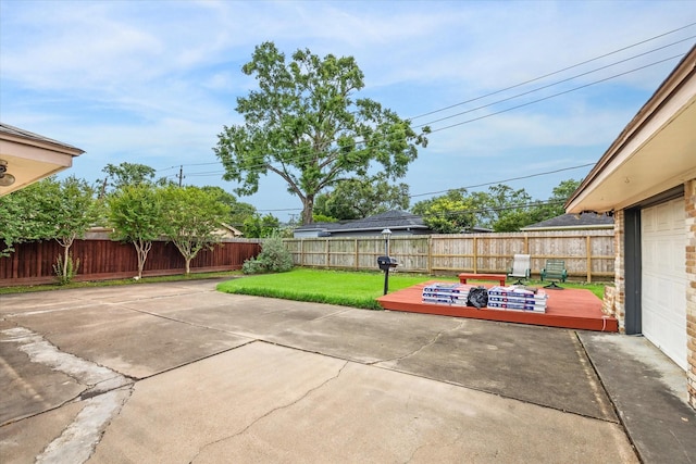 view of patio with a deck and a fenced backyard