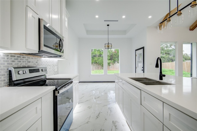 712 Sealy St, Clute, TX 77531 - kitchen with decorative backsplash, a sink, a raised ceiling, marble finish floor, and stainless steel appliances
