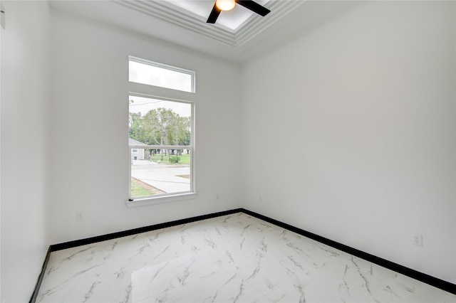 712 Sealy St, Clute, TX 77531 - empty room featuring a ceiling fan, marble finish floor, and a tray ceiling