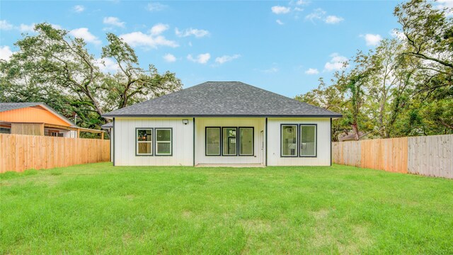 712 Sealy St, Clute, TX 77531 - rear view of house featuring a lawn, a fenced backyard, and roof with shingles