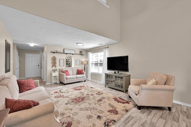 living room with light wood-style floors and baseboards