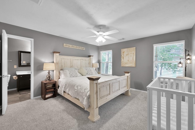 bedroom with light colored carpet, baseboards, and visible vents