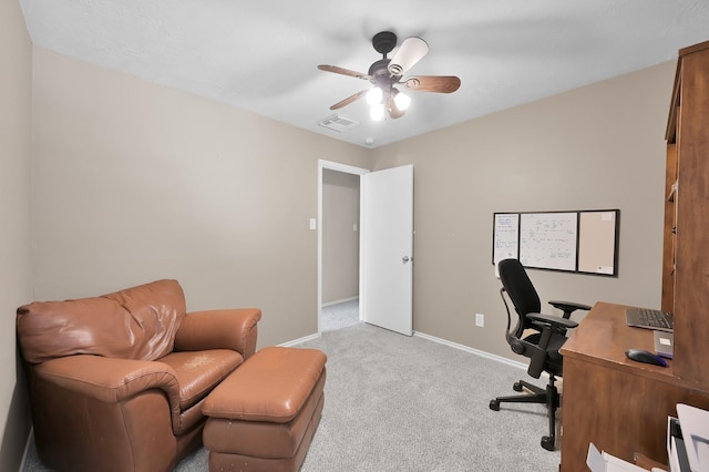 office space with baseboards, a ceiling fan, carpet flooring, and visible vents