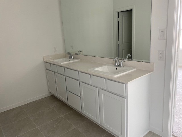 3049 Harrier Dr, Katy, TX 77493 - bathroom featuring double vanity, baseboards, a sink, and tile patterned floors