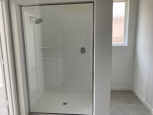 3049 Harrier Dr, Katy, TX 77493 - bathroom featuring baseboards, a shower stall, and tile patterned flooring
