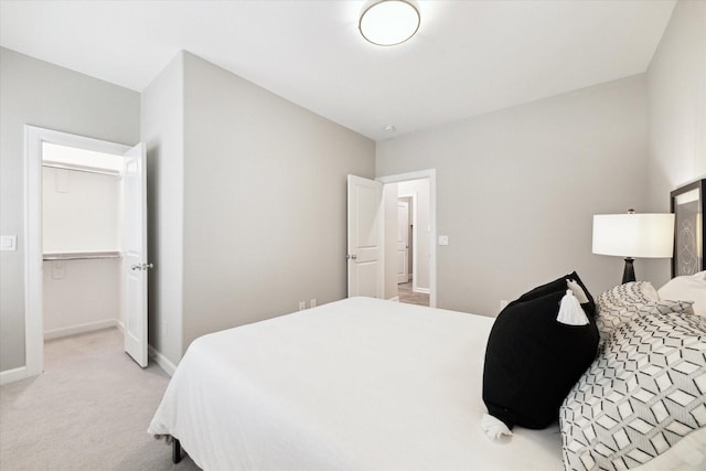 bedroom featuring baseboards and light colored carpet
