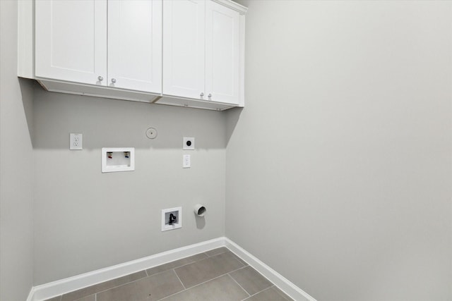 laundry area with gas dryer hookup, washer hookup, electric dryer hookup, cabinet space, and baseboards