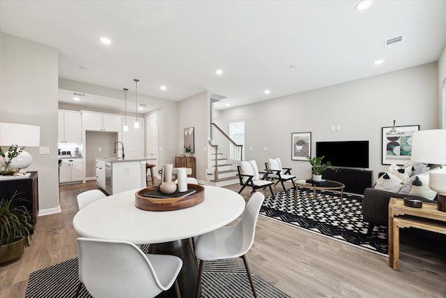 dining area featuring stairs, recessed lighting, visible vents, and light wood finished floors