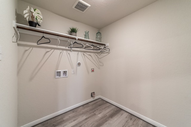 laundry area with washer hookup, laundry area, electric dryer hookup, visible vents, and wood finished floors