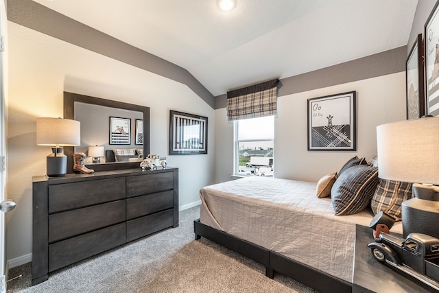bedroom featuring baseboards, vaulted ceiling, and carpet