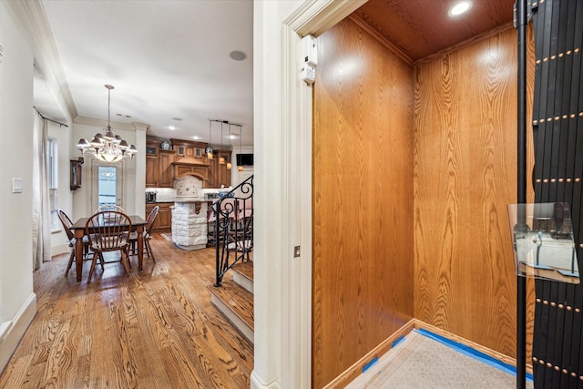 interior space featuring recessed lighting, baseboards, a notable chandelier, and wood finished floors