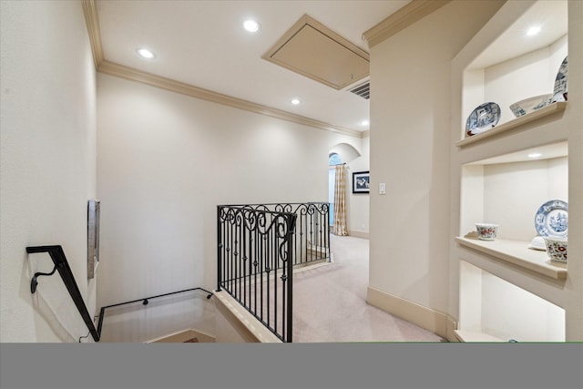 hallway featuring recessed lighting, ornamental molding, an upstairs landing, and attic access