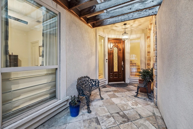 property entrance featuring stucco siding