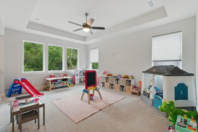 9726 Dani Lake Dr, Tomball, TX 77375 - recreation room with a tray ceiling, carpet, and a ceiling fan
