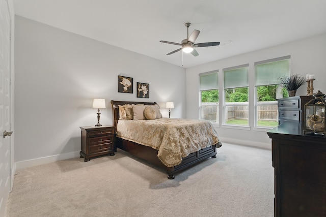 9726 Dani Lake Dr, Tomball, TX 77375 - bedroom featuring light colored carpet, baseboards, and ceiling fan