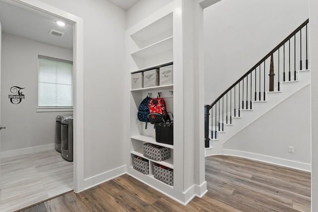 9726 Dani Lake Dr, Tomball, TX 77375 - mudroom with separate washer and dryer, wood finished floors, and baseboards