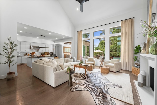 living area featuring recessed lighting, ceiling fan, wood finished floors, and high vaulted ceiling