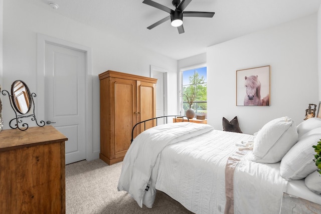 bedroom with ceiling fan and light carpet