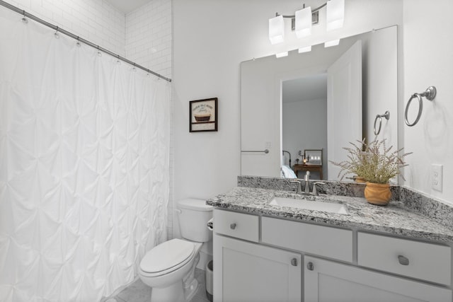 ensuite bathroom with ensuite bathroom, a shower with shower curtain, toilet, and vanity