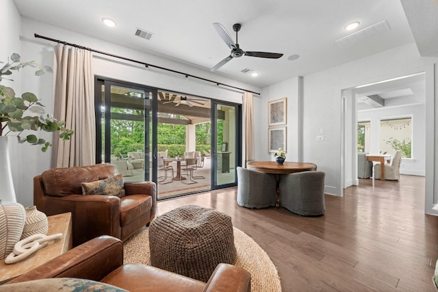 living area with visible vents, recessed lighting, ceiling fan, and wood finished floors