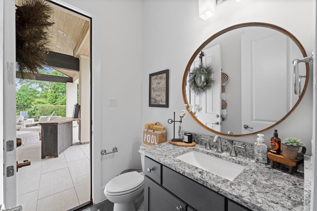 bathroom with toilet, tile patterned flooring, and vanity