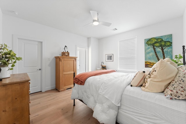 bedroom featuring ceiling fan, visible vents, and light wood-type flooring