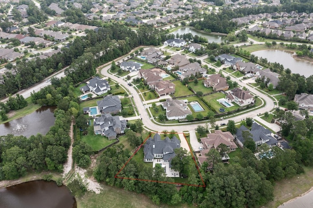 drone / aerial view with a residential view and a water view