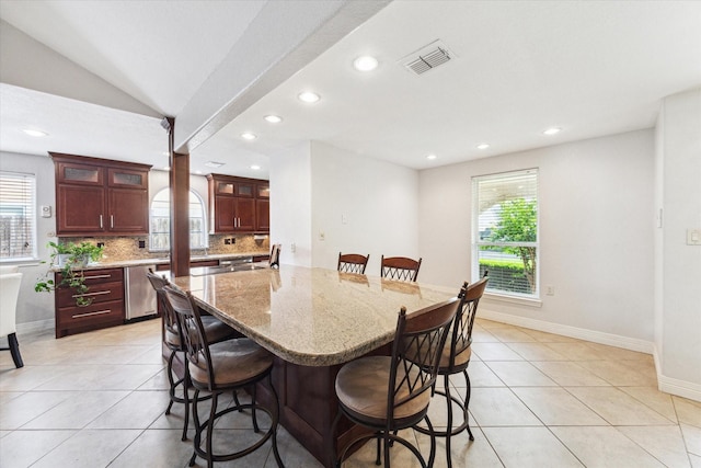 dining space with a healthy amount of sunlight, light tile patterned flooring, and visible vents