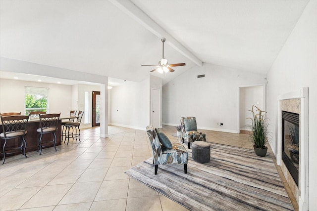 living area featuring a ceiling fan, visible vents, light tile patterned floors, high vaulted ceiling, and beamed ceiling