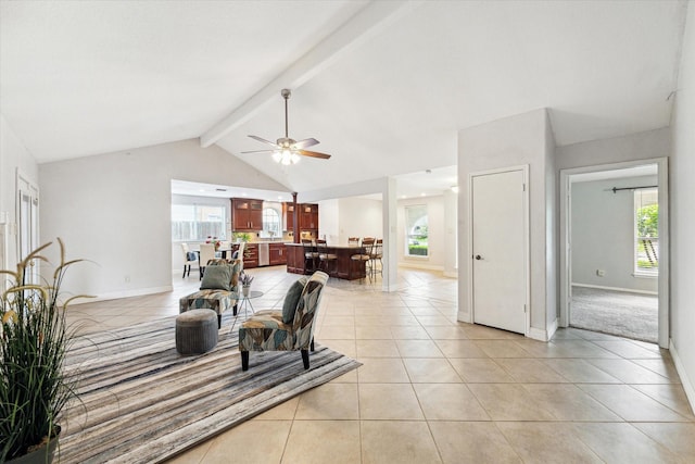dining space featuring baseboards, ceiling fan, light tile patterned floors, and vaulted ceiling with beams