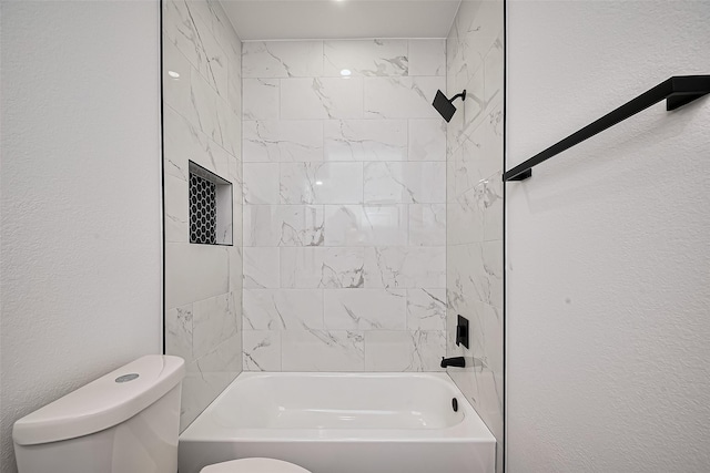 bathroom with toilet and washtub / shower combination