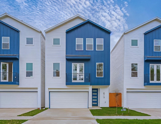 view of front of house with a garage, board and batten siding, and driveway