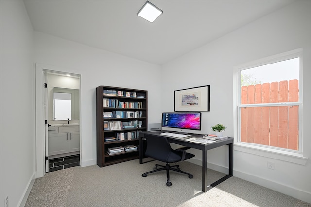 office space with baseboards and carpet flooring