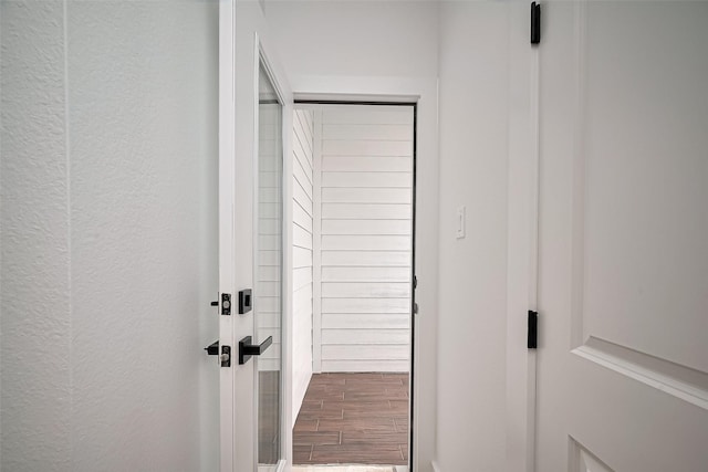 interior space featuring a textured wall and wood finished floors